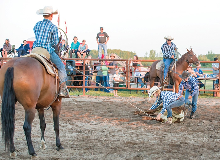 Ranch rodeo consists of four-person teams that compete in events that reflect the day-to-day activities of working cowboys. Above is a local team competing at the McAuley ranch rodeo held a few weeks ago.